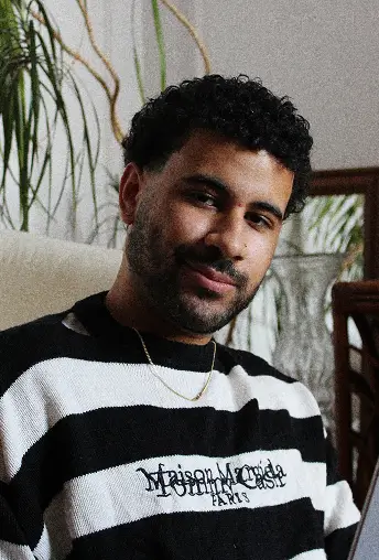 Small headshot of Karim with a calm expression, shown beside a personal quote.