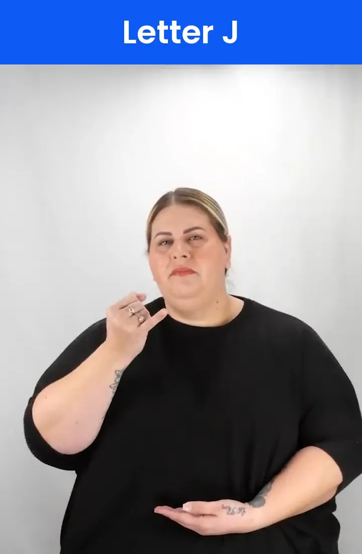 A Deaf signer signs J in ASL