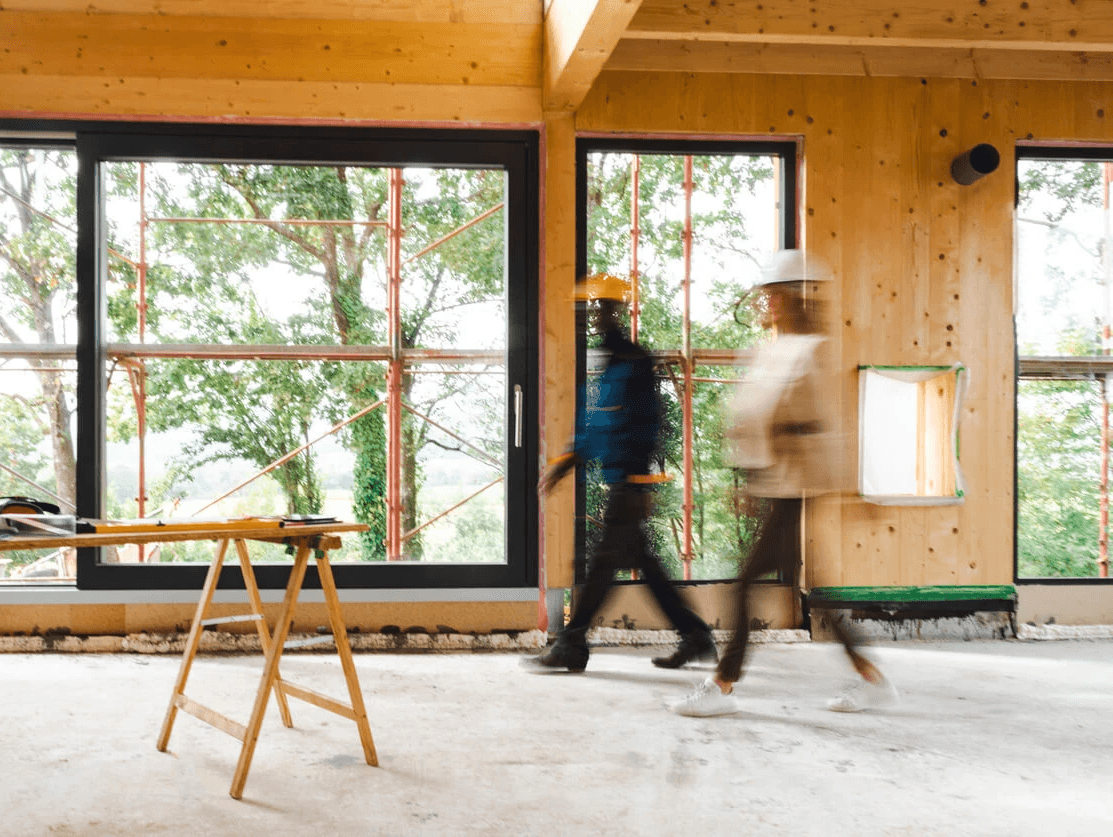 a man holding a large hammer in a room