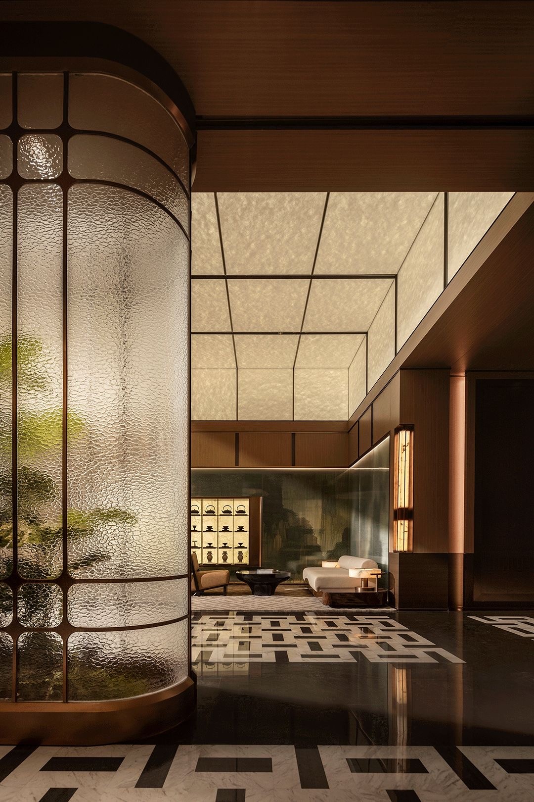 Outdoor corridor with brick arch windows, stucco grid wall, wooden pergola, and dramatic sunlight shadows.