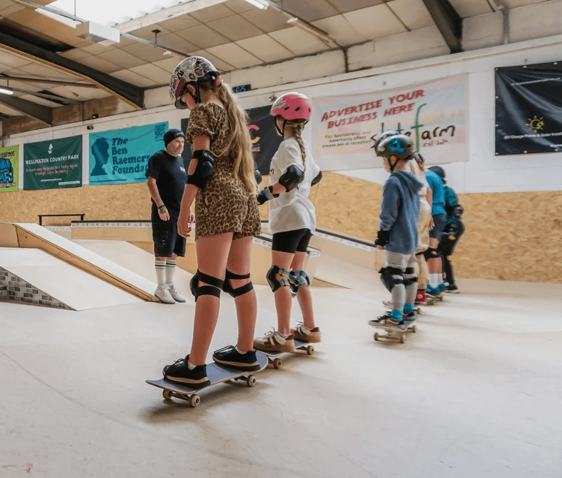 Children learning to skateboard at The Skate Farm indoor skatepark in Haywards Heath, Sussex