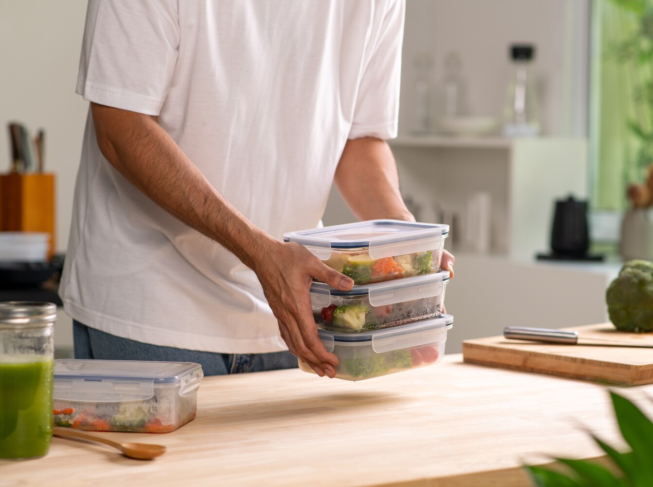 man preparing healthy meals for the week to support his stationary bike workout for weight loss