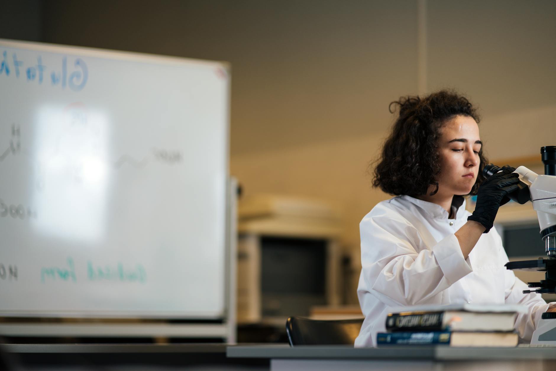 Close-up of a science teacher in a lab coat holding a beaker next to a history teacher reviewing a vintage map.