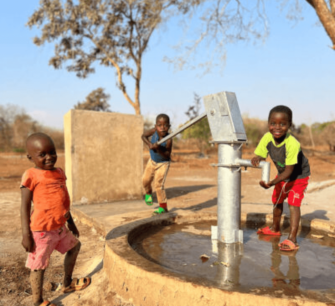 Children at a water well built by Osmow's Hope Fund in a developing community
