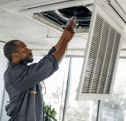 HVAC technician performing professional duct cleaning in a Mississauga home to improve airflow, remove dust buildup, and enhance indoor air quality.