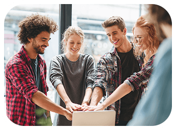 A group of three people are engaged in conversation, smiling in a modern indoor setting.