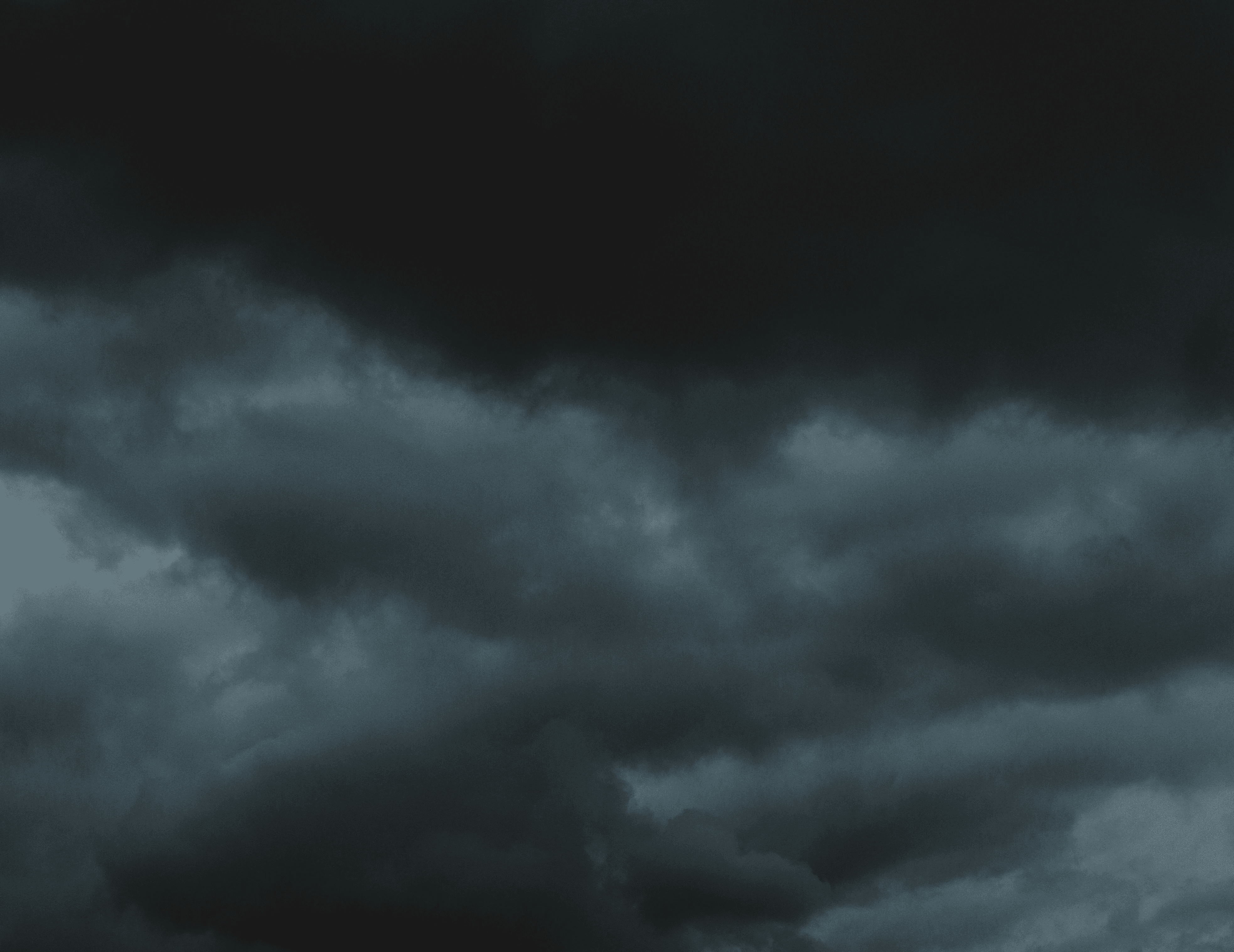 city skyline under dark clouds