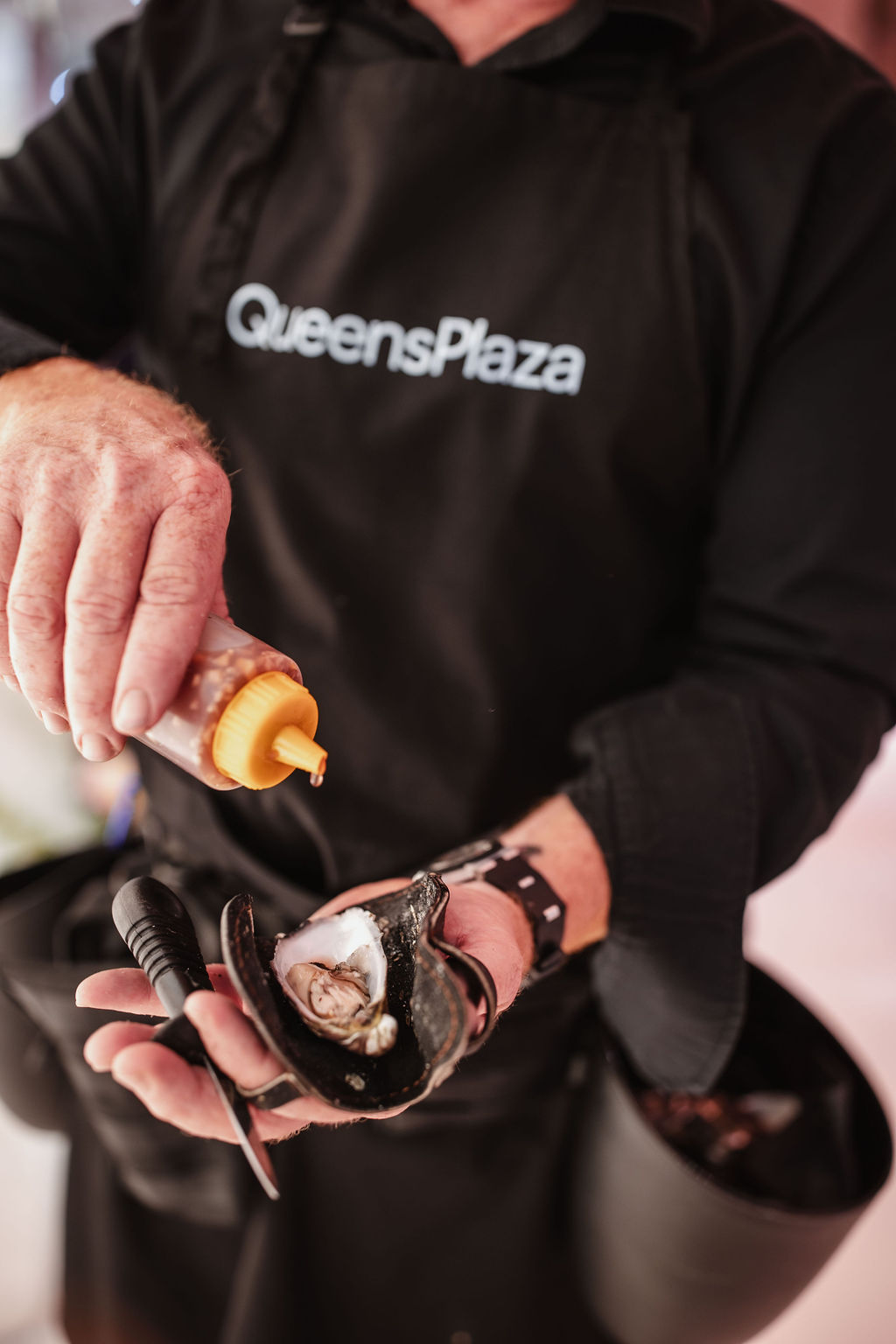 Roaming oyster shucking service at Queens Plaza