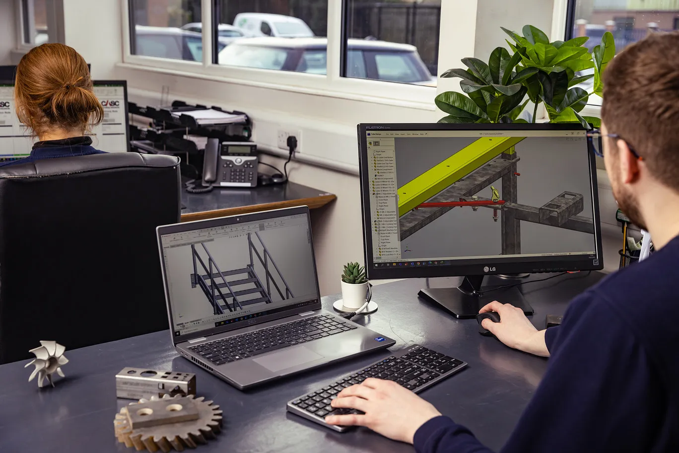 CASC employees reviewing information on a laptop together in an office environment.