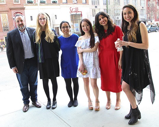 a group photo of six people on the sidewalk