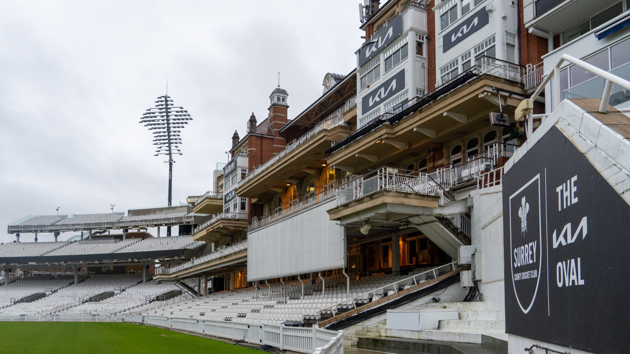 Two classic volkswagen beetles, one green, one cream.