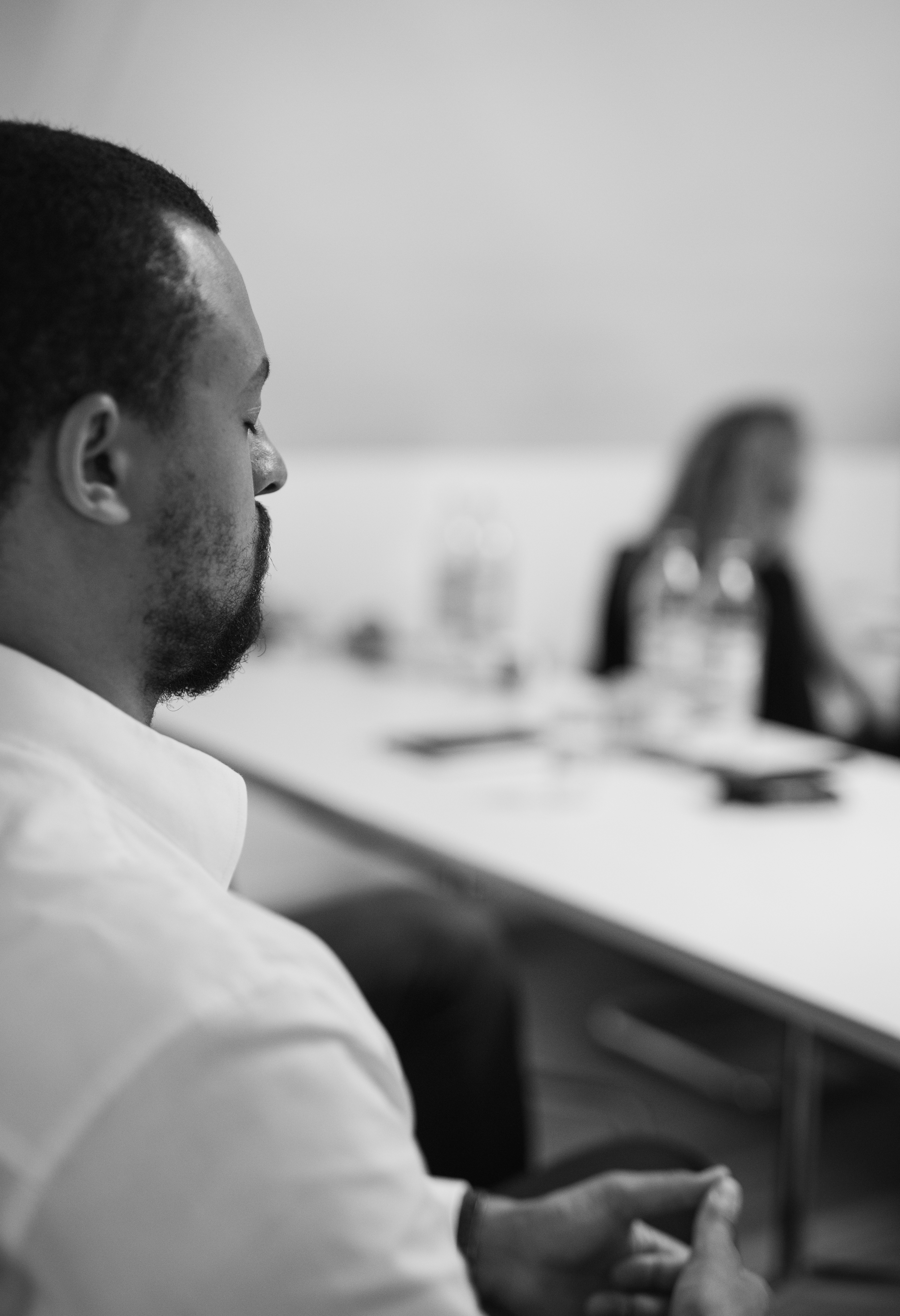 woman in brown coat using macbook air