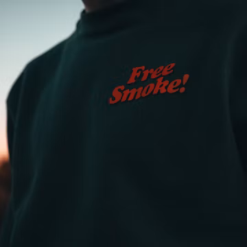 a man wearing a black sweatshirt with a red slogan on it