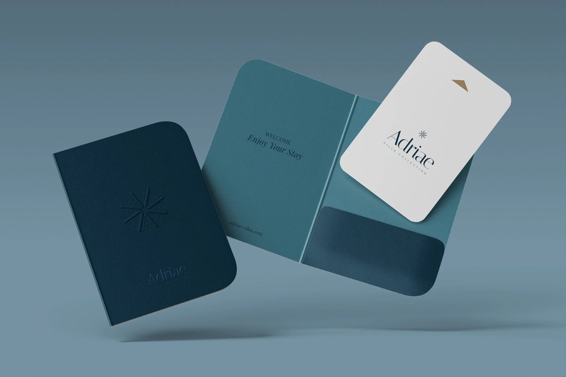 A high-end guest check-in mockup displaying a premium branded key card sleeve and custom room key card design for Adriae villas by Studio Liminal.
