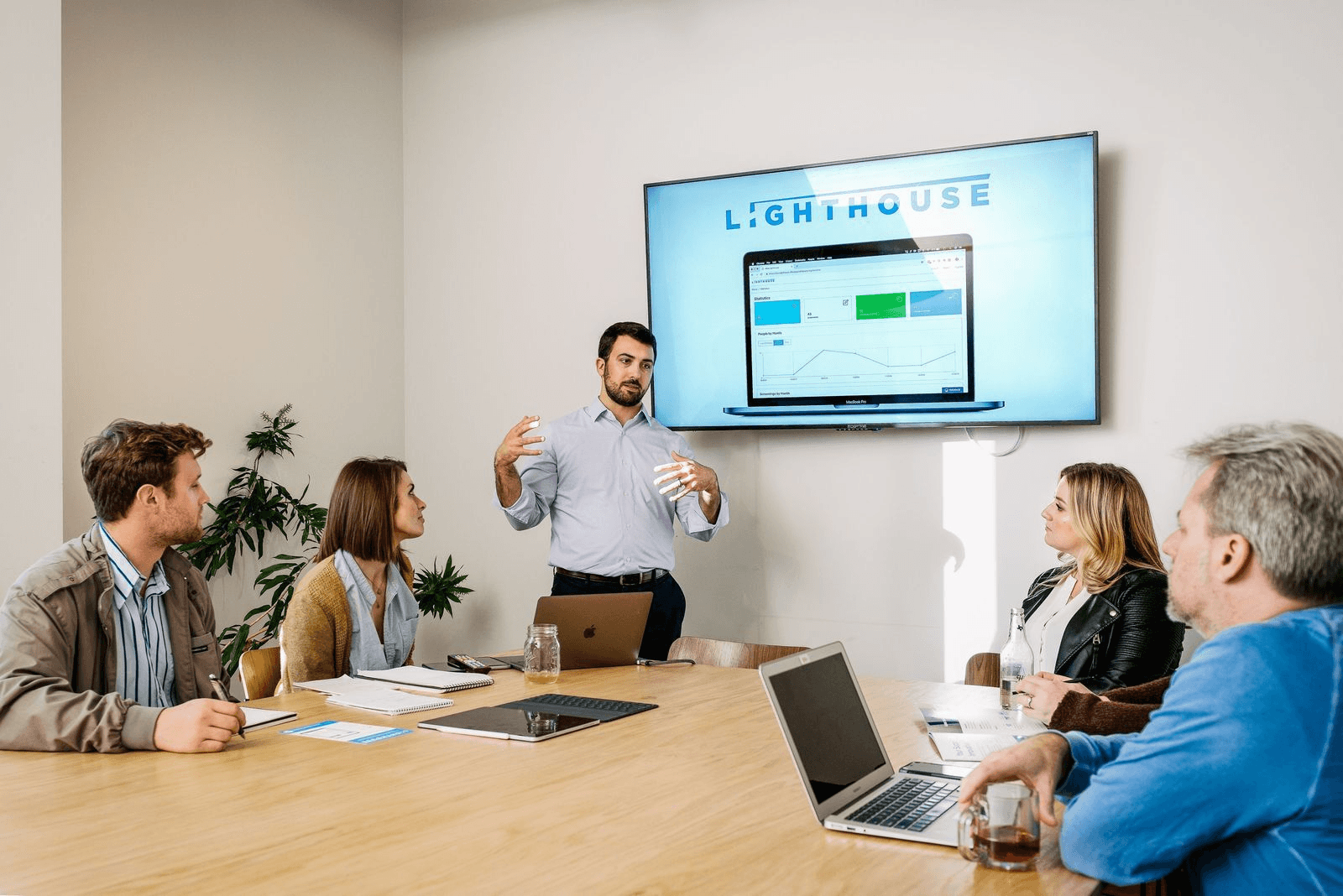 Allies Against Slavery team members Tally Jorn (center left), John Nehme, and Torey Tipton (center right) providing a tutorial of the Lighthouse platform. (Image courtesy of John Davidson)