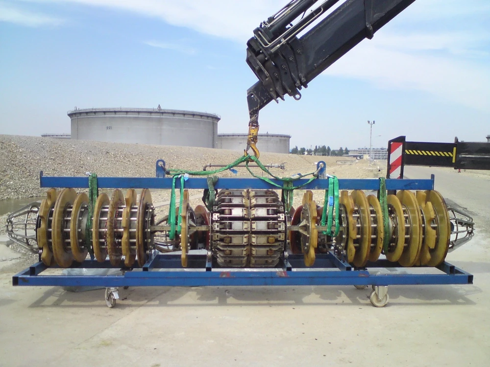 A pipeline inspection gauge being lifted by a crane. Used for industrial applications. 
