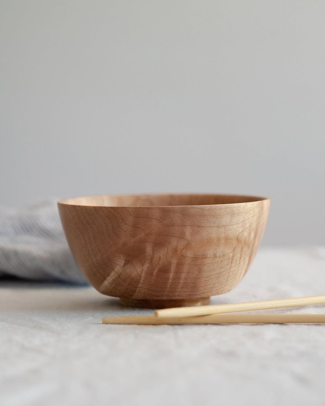 Full moon rising over a dark, silhouetted mountain ridge.
