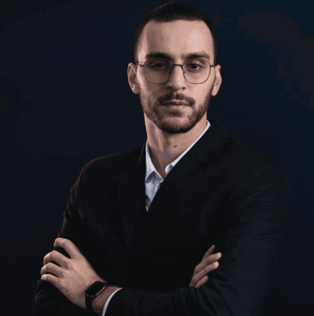 a man in a blue suit posing for a picture