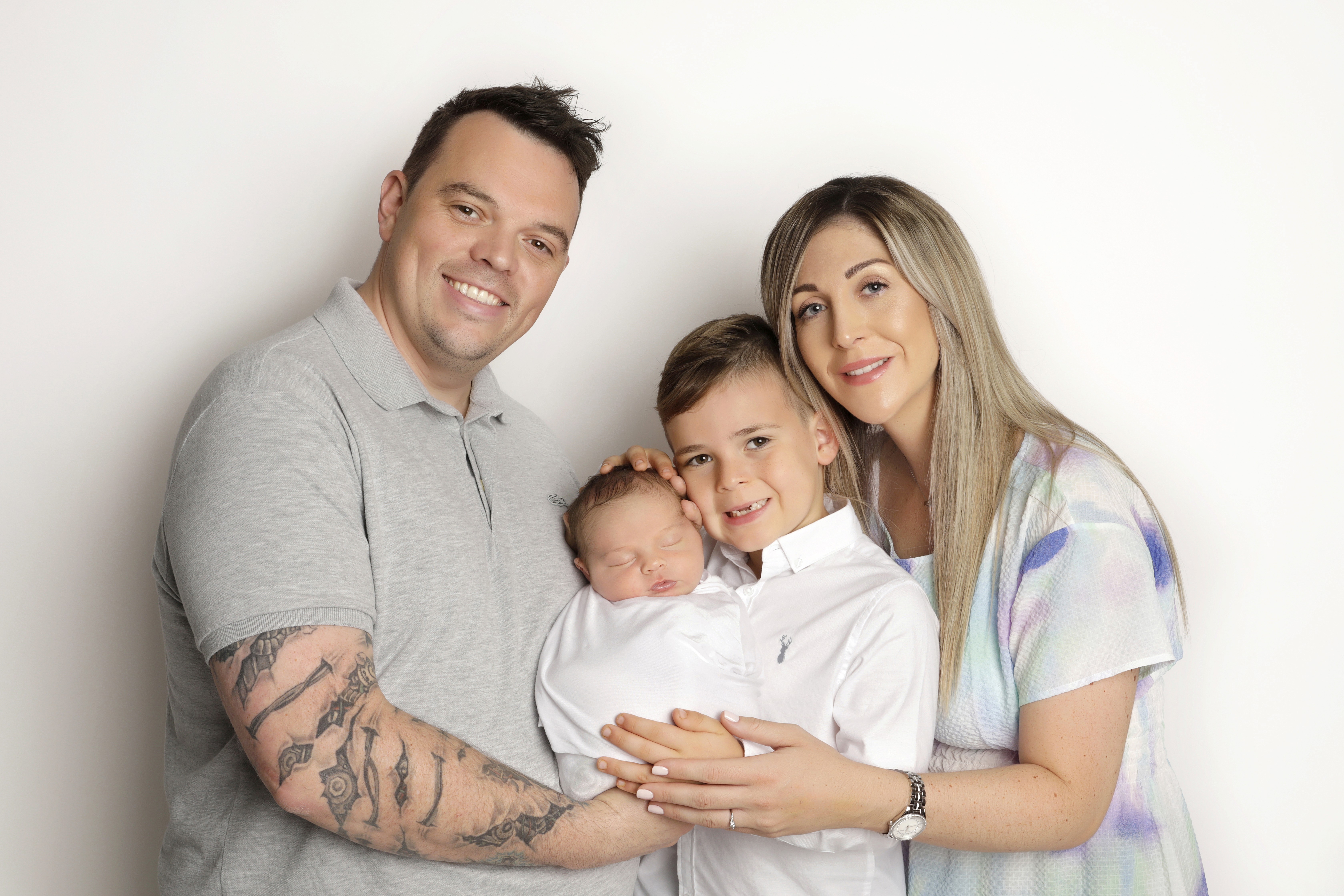 Family posing for a newborn hospital photo as a complete unit.
