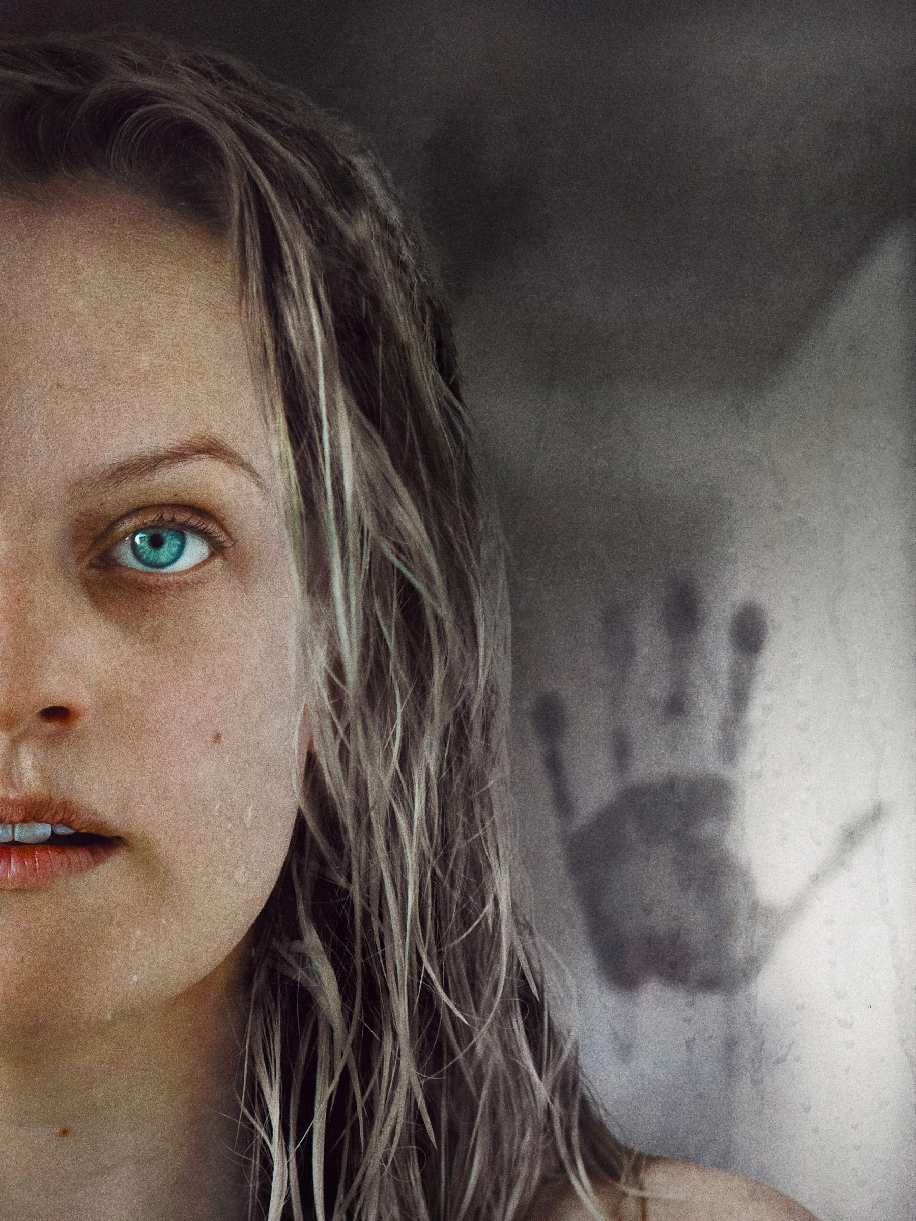 Movie poster for “The Invisible Man” showing a woman’s face with wet hair and a handprint on fogged glass behind her.
