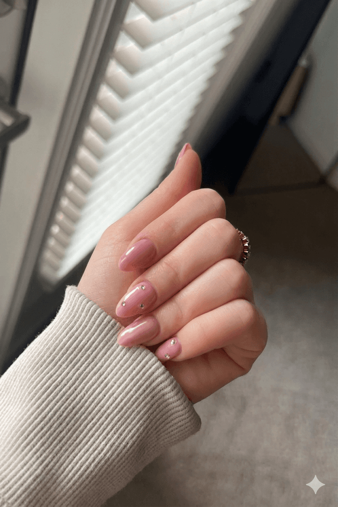 Hand with glittery pastel nails in sunlight