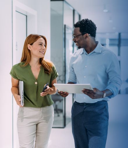 male and female business people walking and talking in medical practice