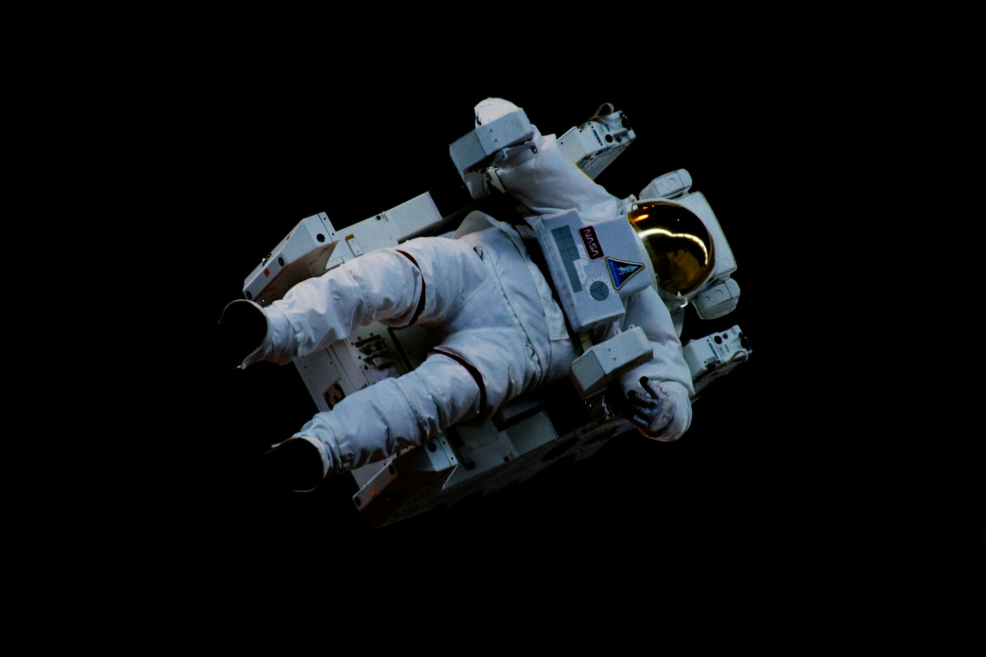 Astronaut floating freely in space against a dark background
