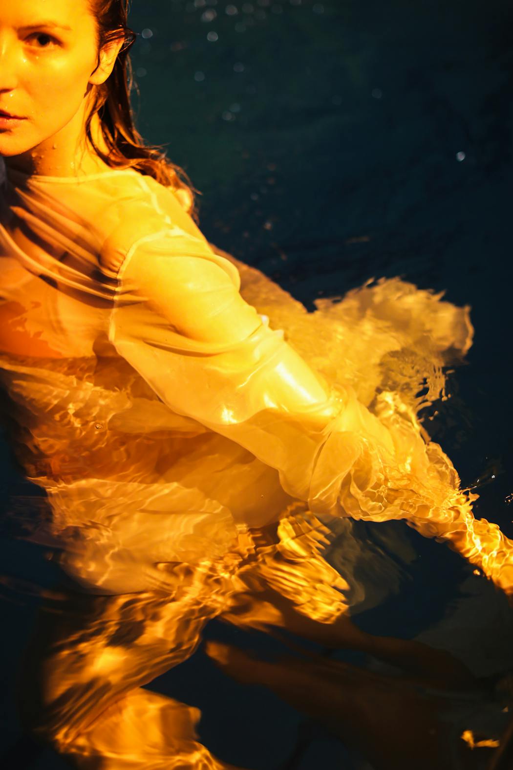 Woman swimming with a white dress