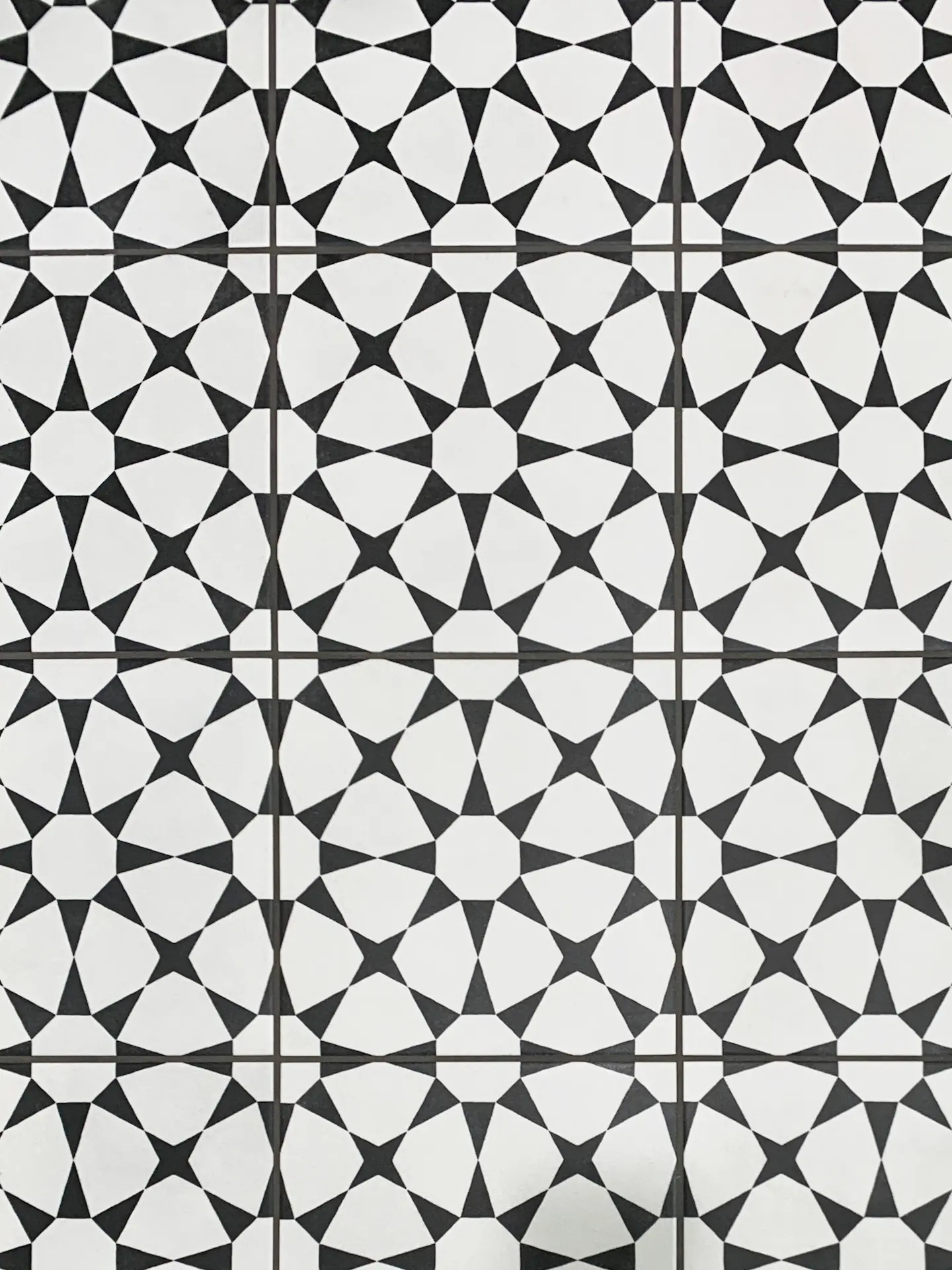 Closeup of the guest bath floor tile, a tasteful choice that complements the contemporary design of the bathroom. Photo by Todd Huge.