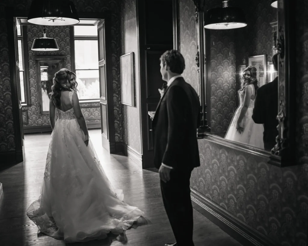 Bride entering a hallway as the groom waits ahead