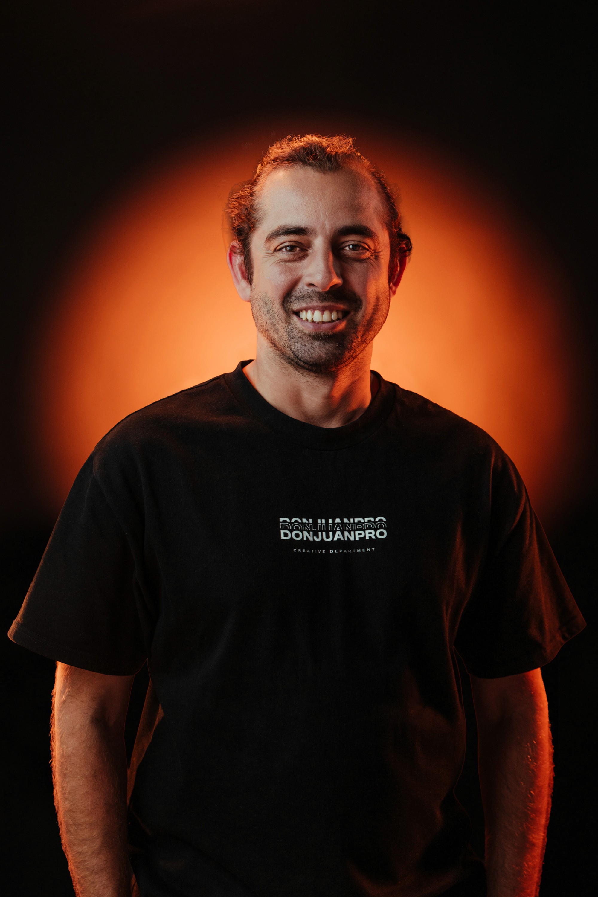 man in black shirt smiling