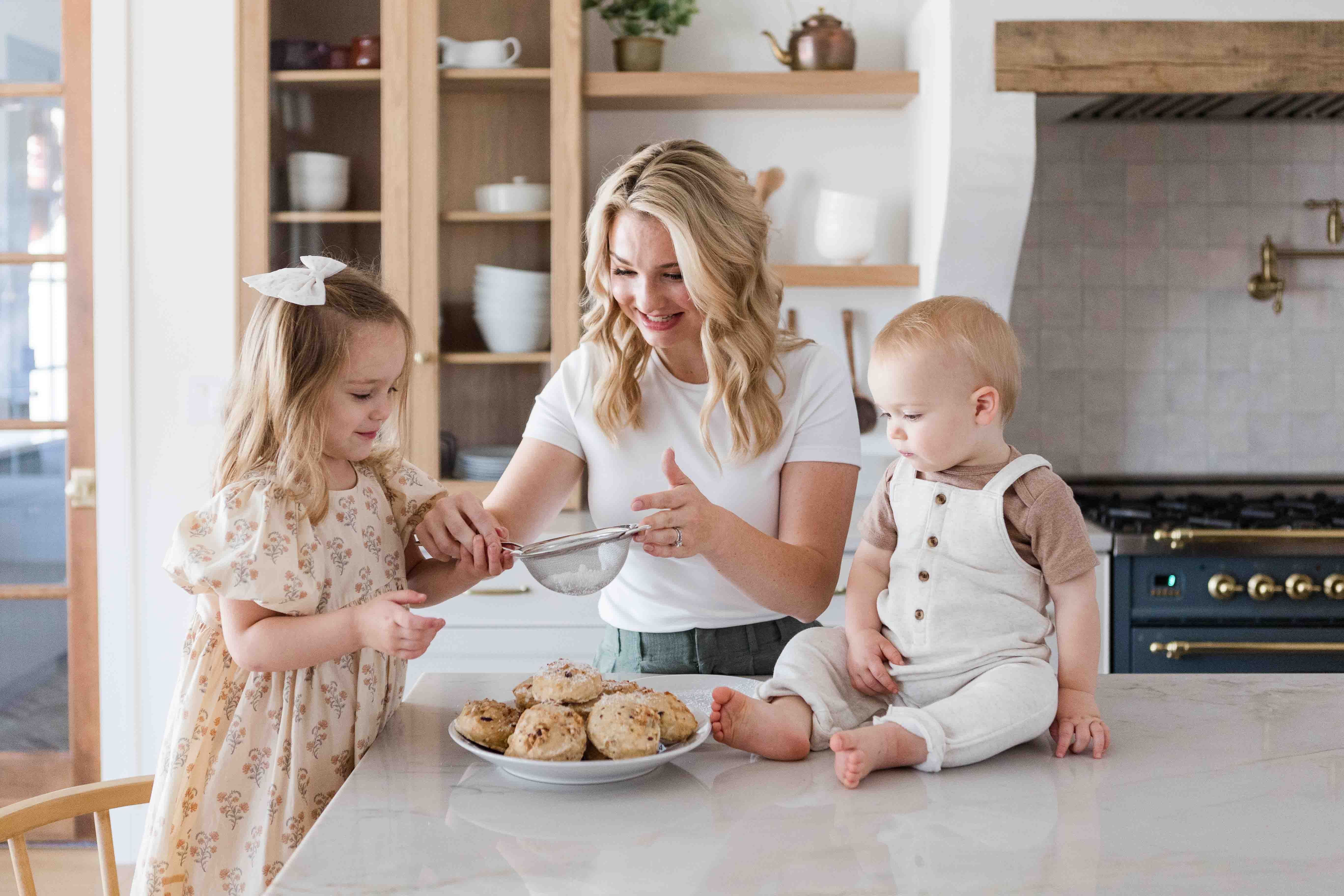 Image of mom baking in the kitchen with her two kids.