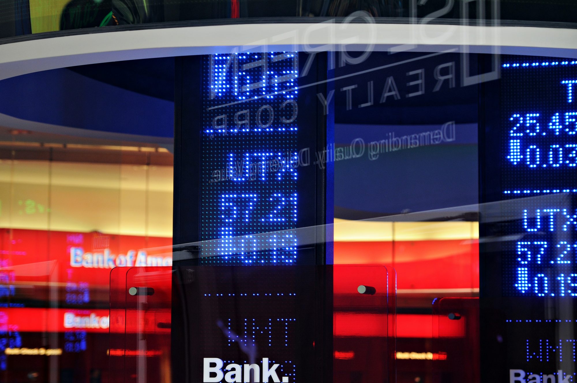Stock exchange display showing financial data with colorful lights in the background.