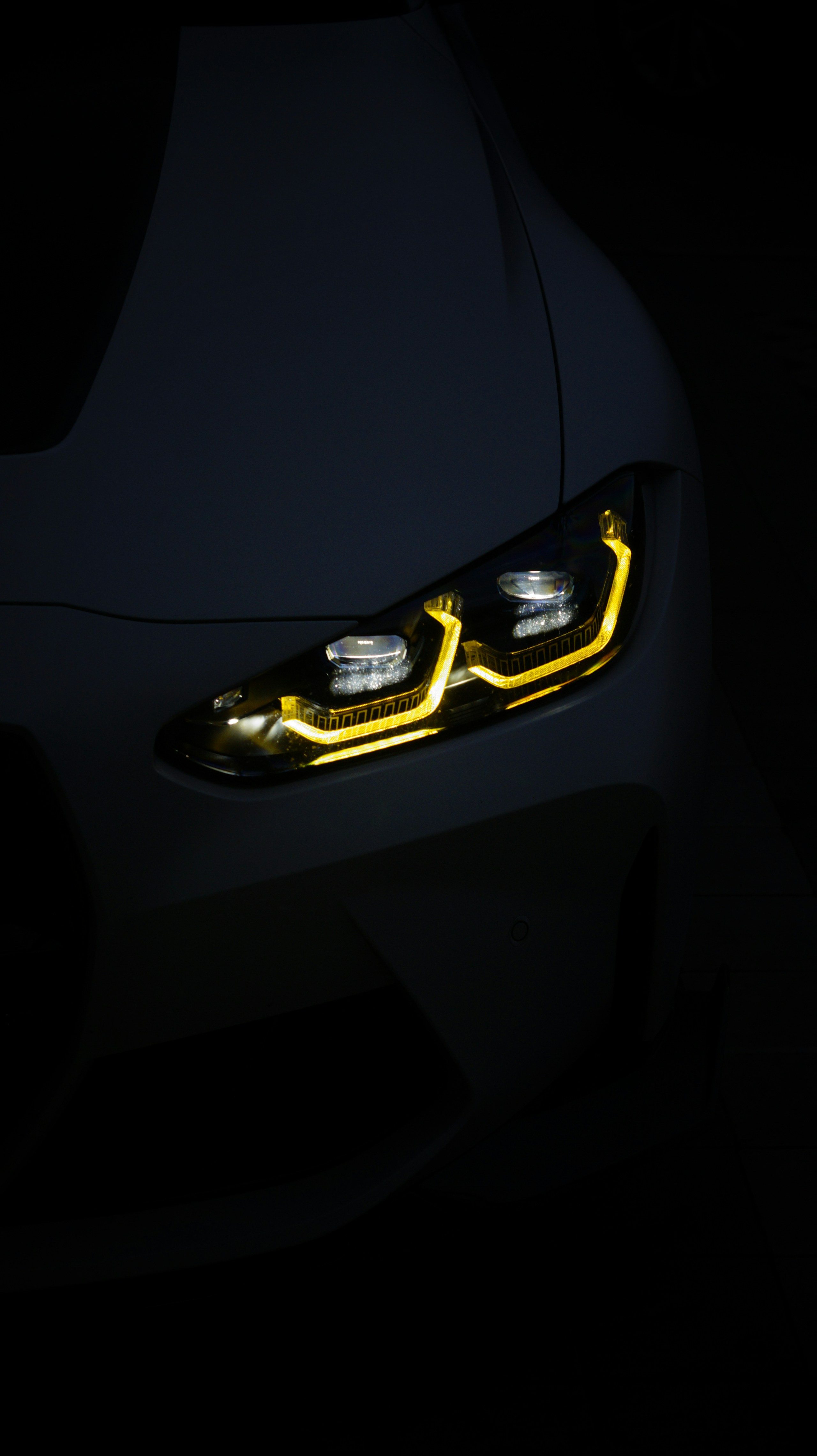 Close-up of a premium sports car headlight and body line