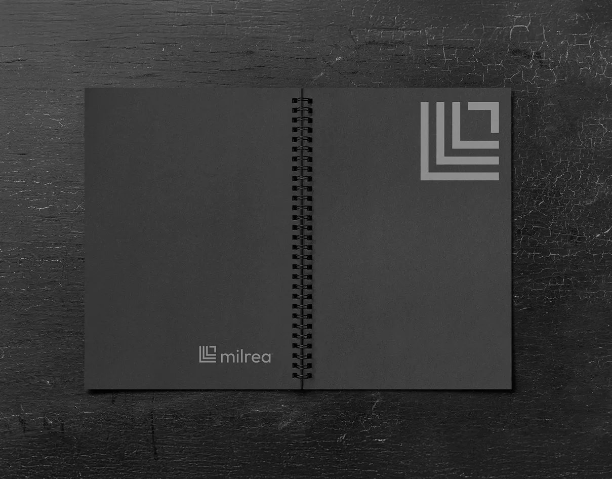 Milrea black spiral notebook with a silver geometric monogram.
