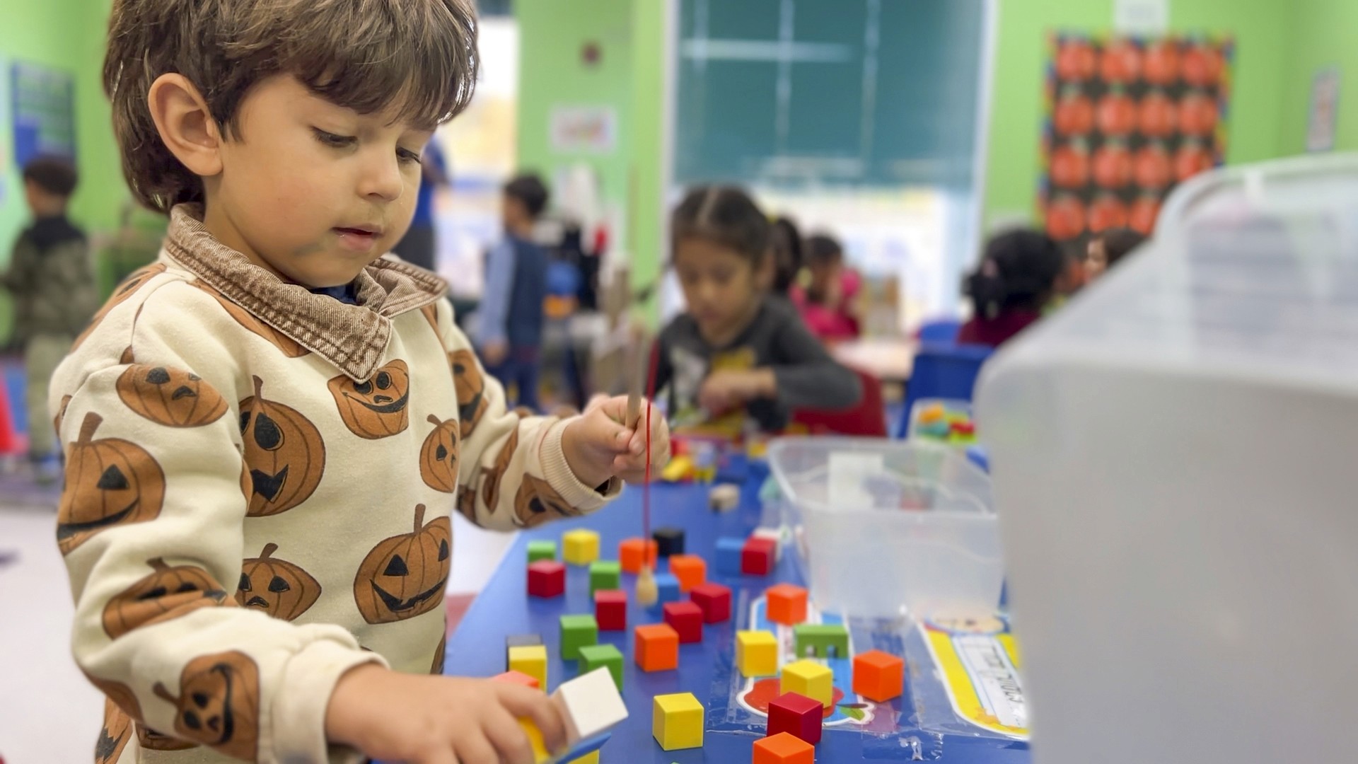 Early learners engaged in holistic development activities at Blooming Buds Learning Center in Syosset.