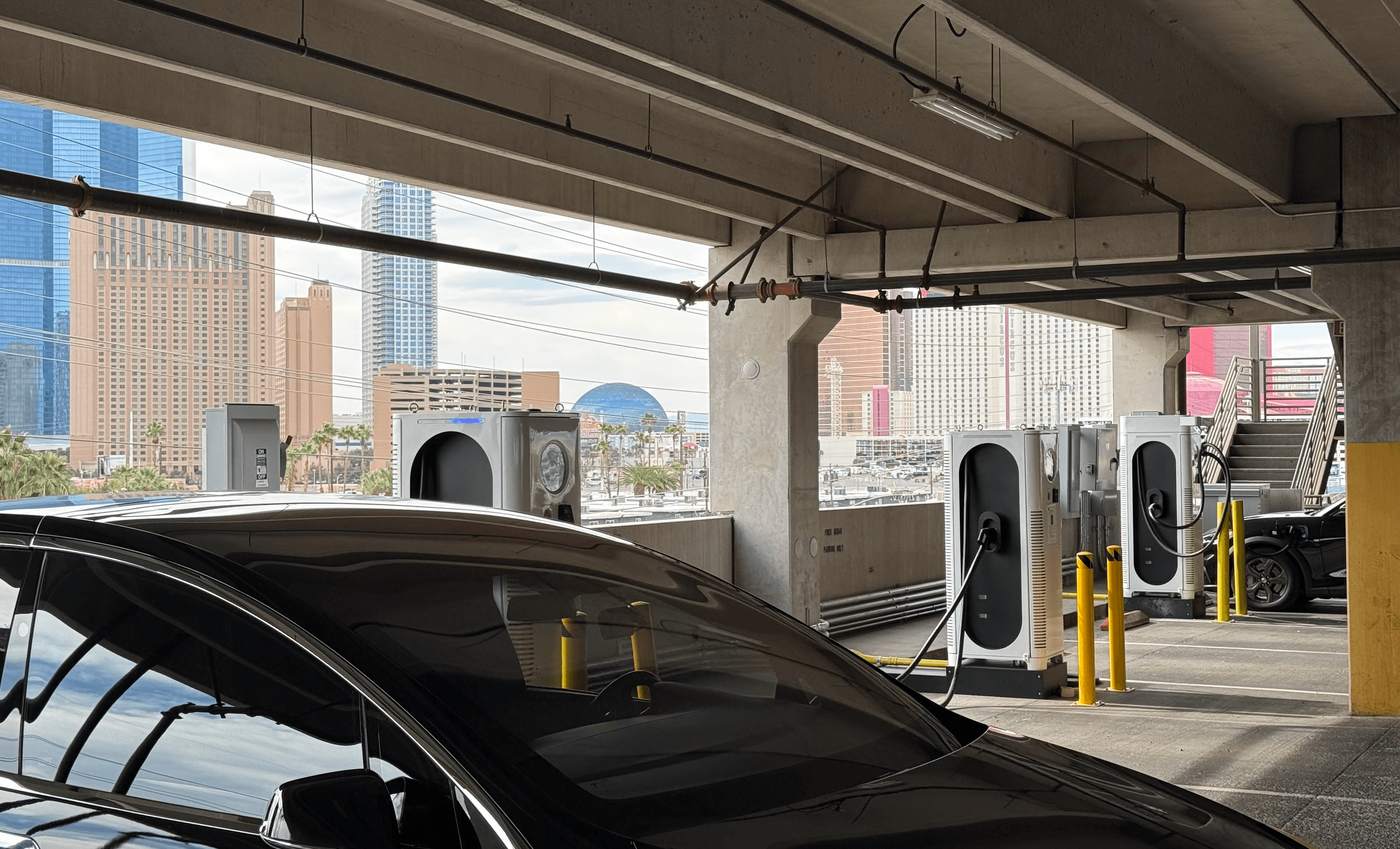 C6AM chargers in a parking lot with a view of las vegas 