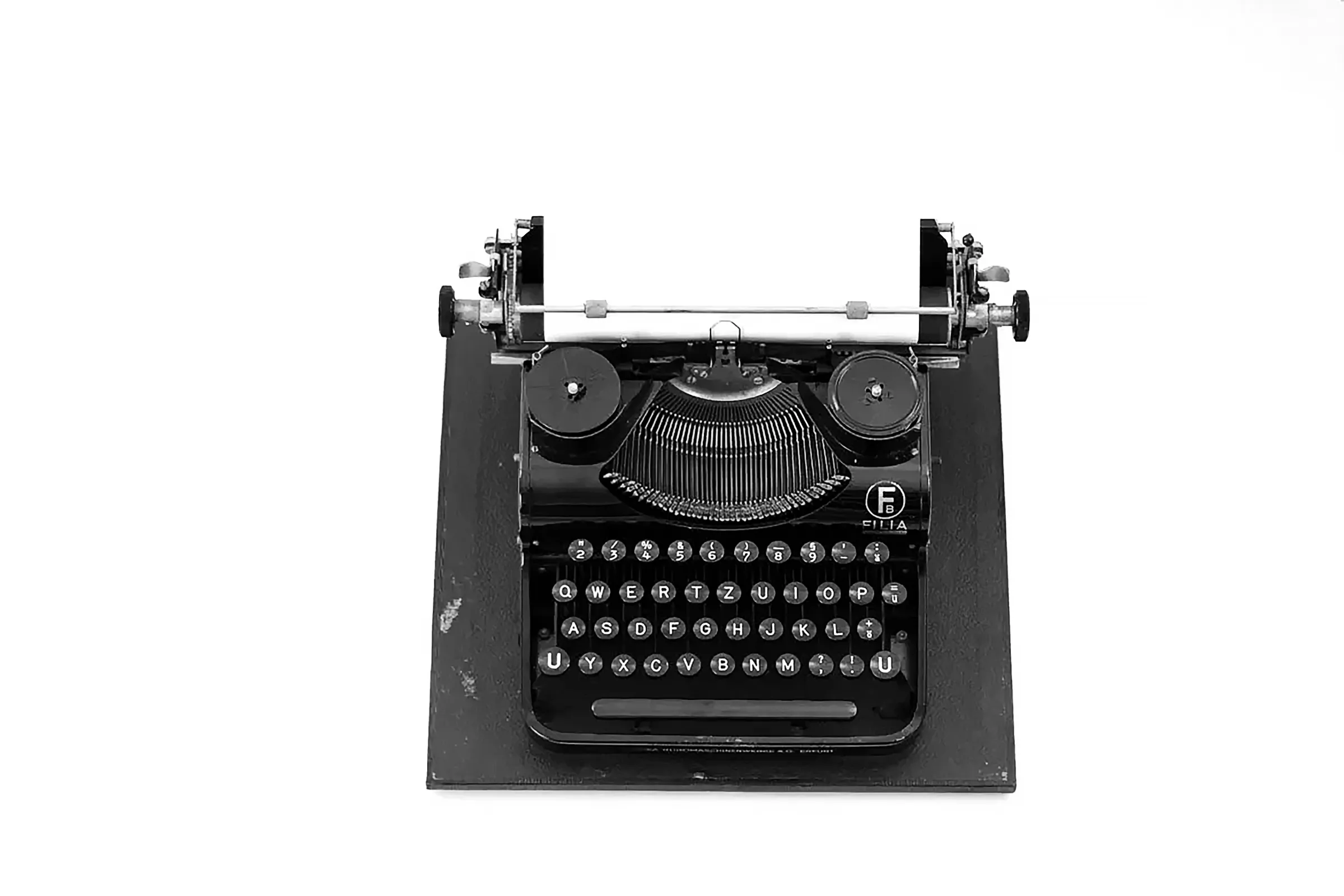 black and white typewriter on white table
