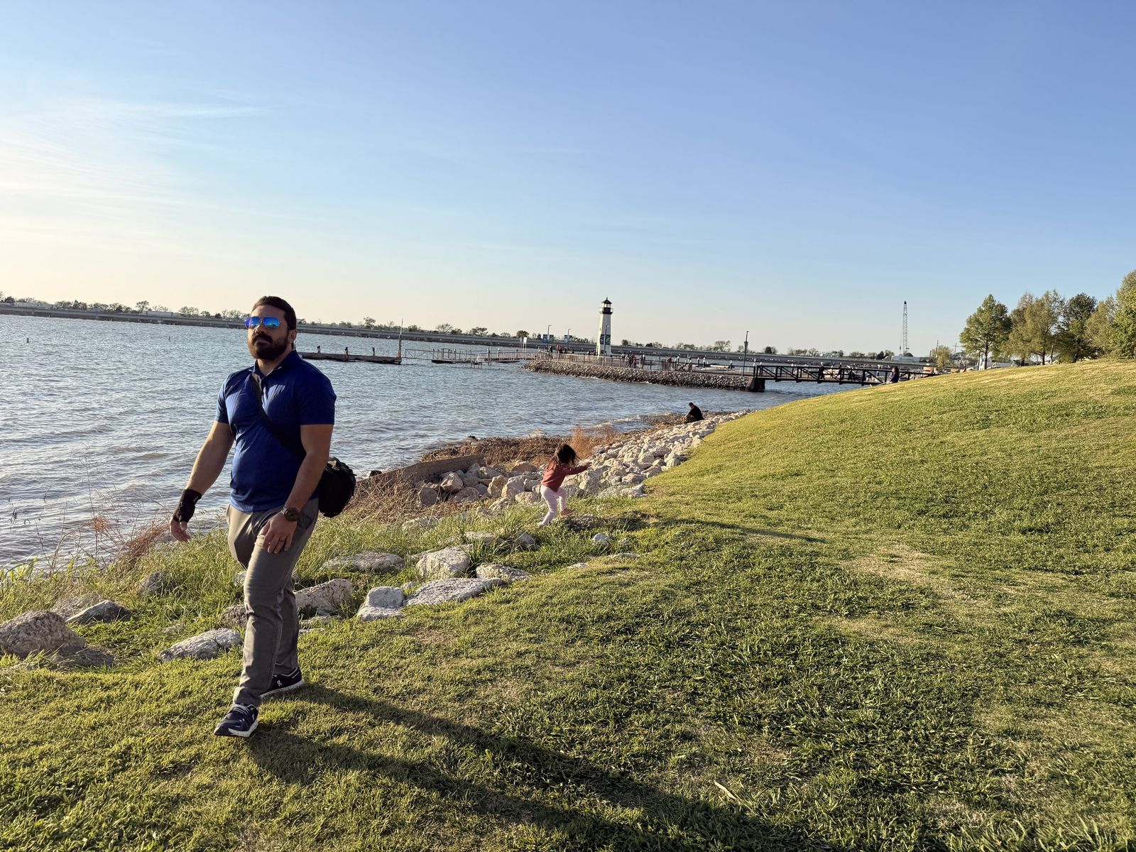 Preston walking the lakeshore near the lighthouse at the Harbor in Rockwall