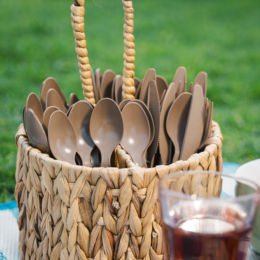 A basket of Palmade cutlery at a picnic