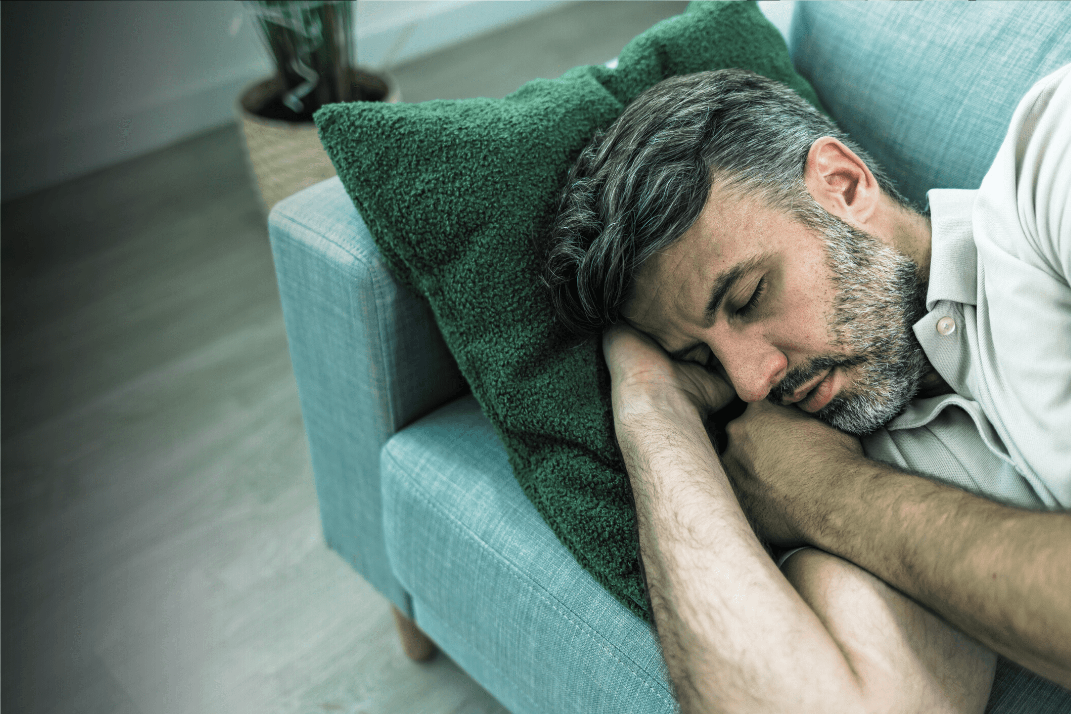 Three people sitting on a couch in a room looking at mobile devices