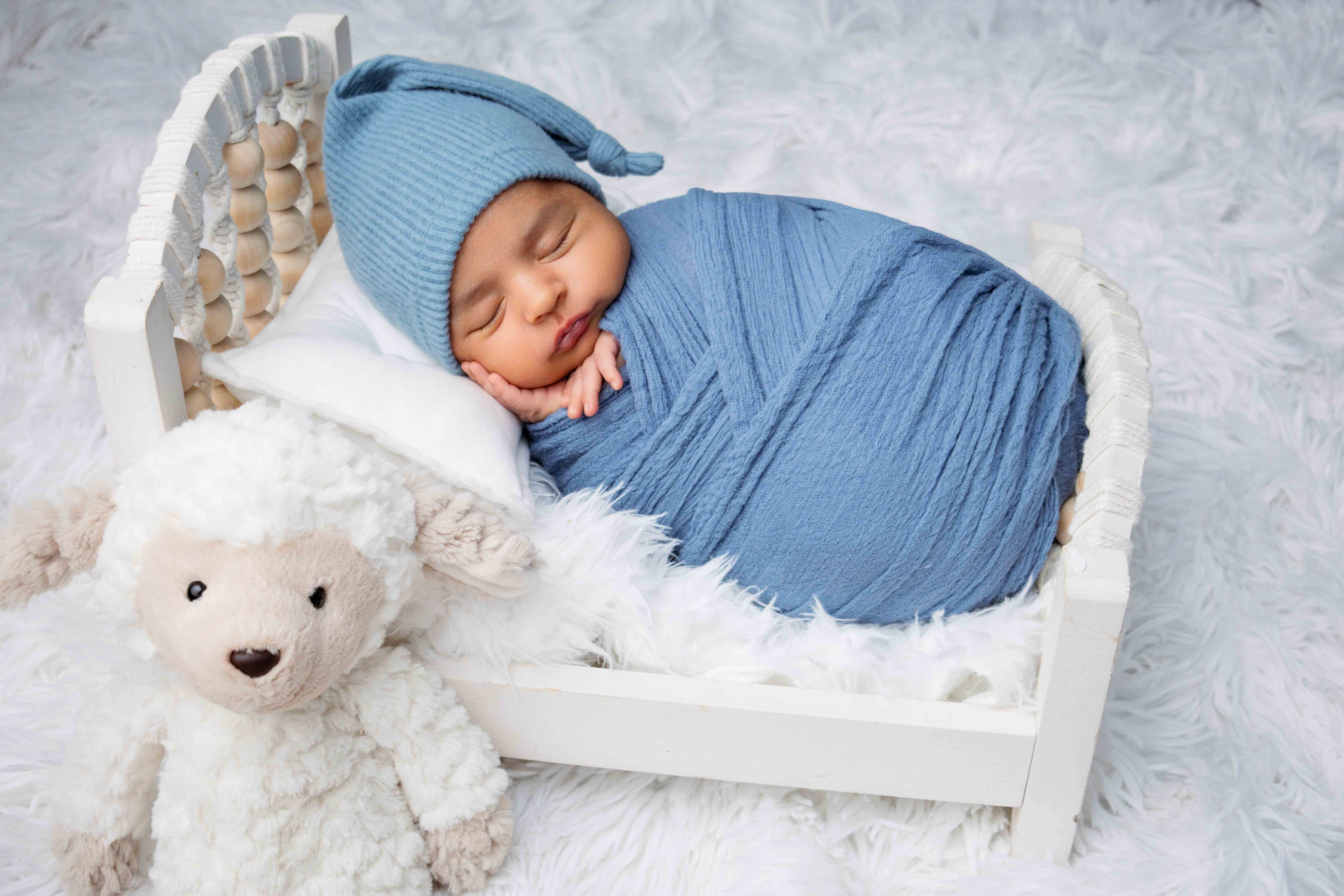 Expecting mom wearing elegant flowing maternity gown during studio photoshoot in Los Angeles.