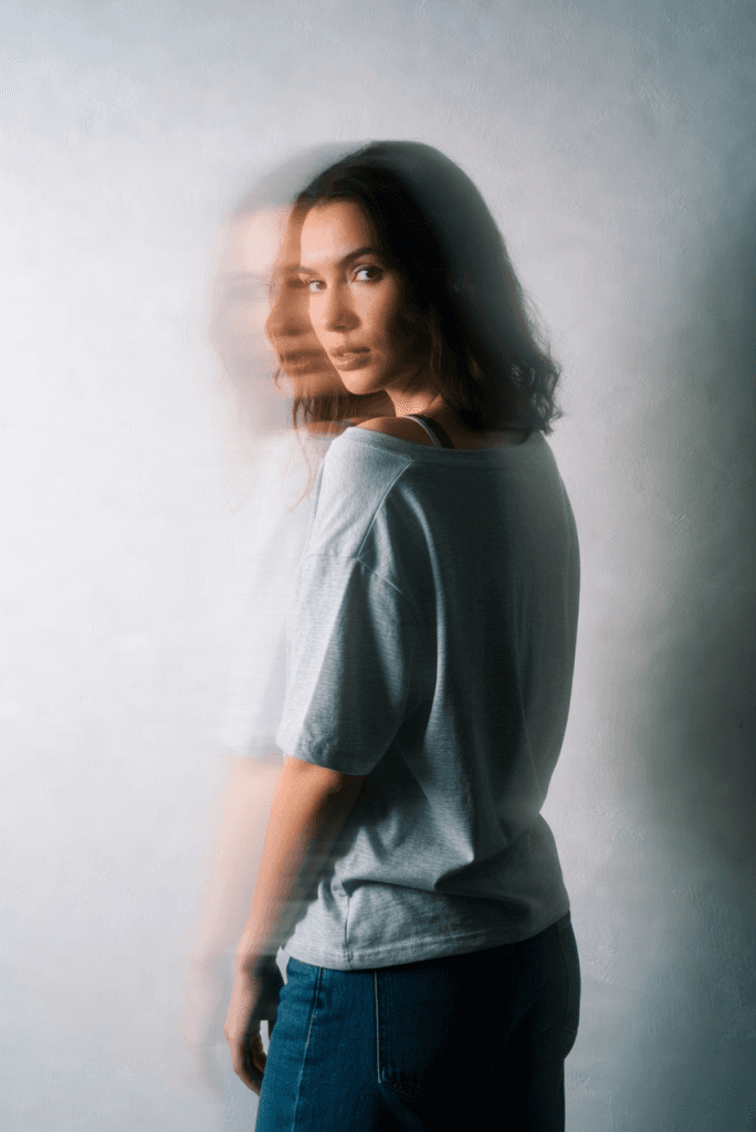 Woman in a gray t-shirt with a motion blur double exposure effect