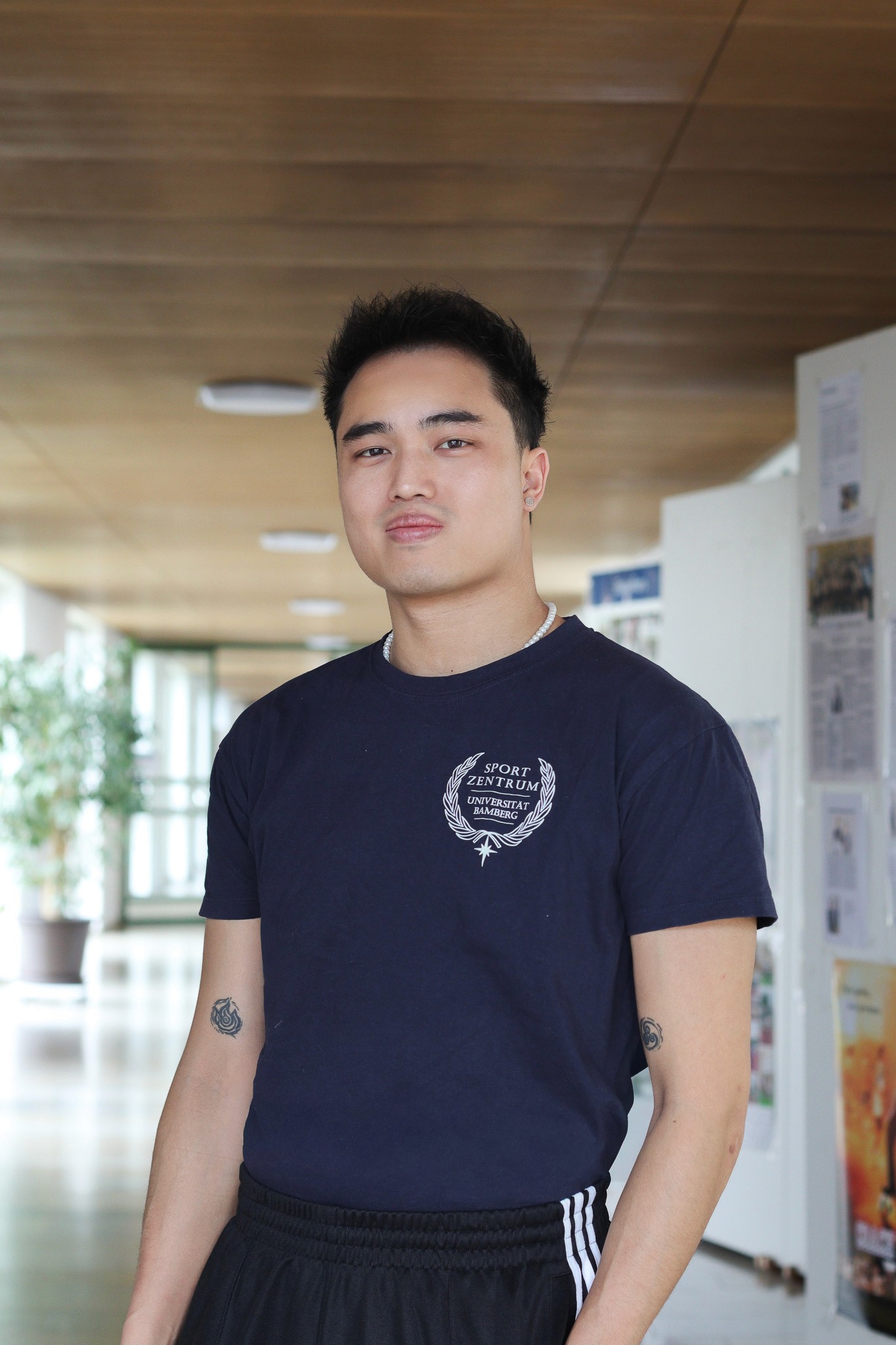 Portrait of Marcel Le in a Sports Department T-shirt