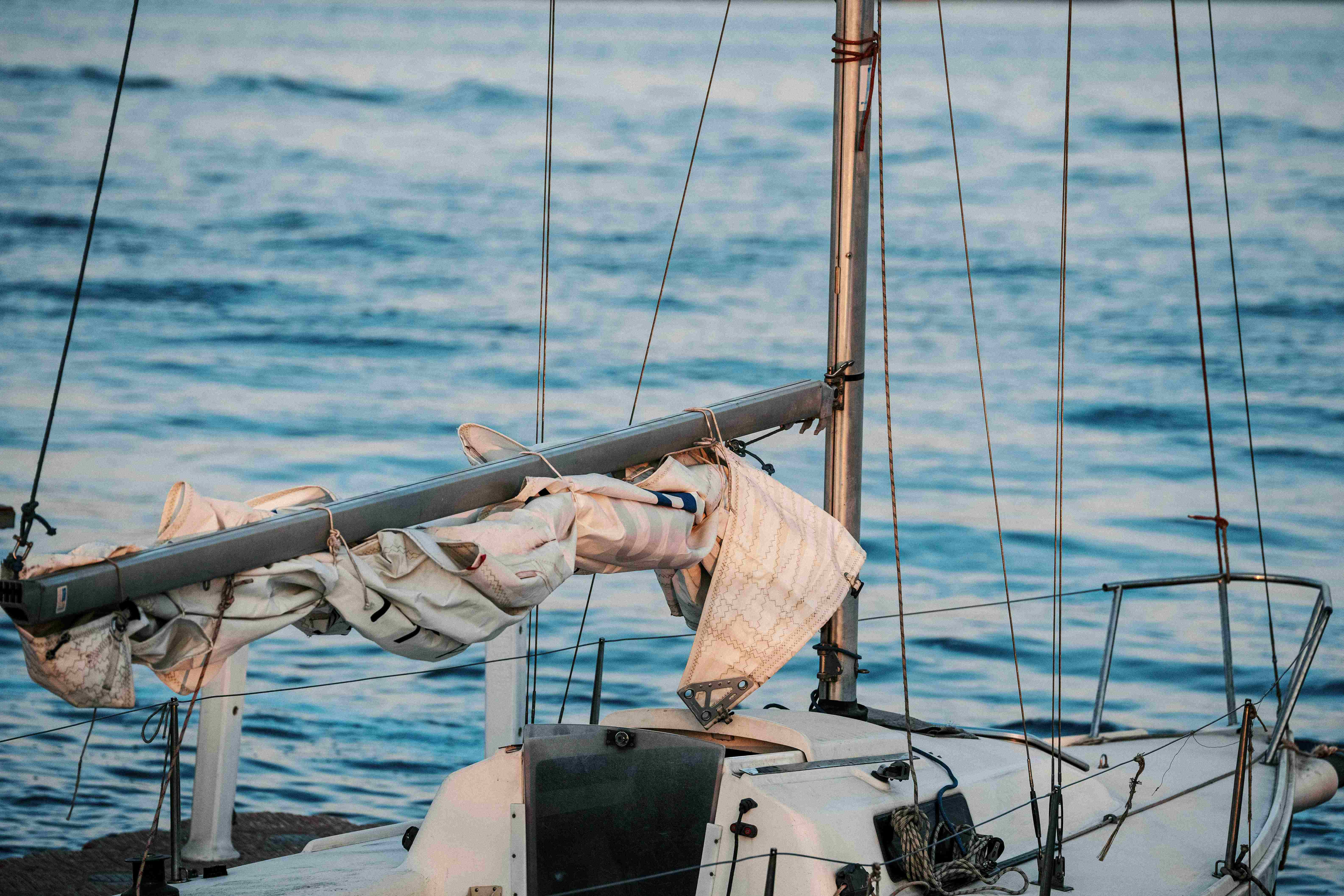 A yacht with sails and equipment showing signs of use at sea, representing operational risks and insurance considerations in maritime activities
