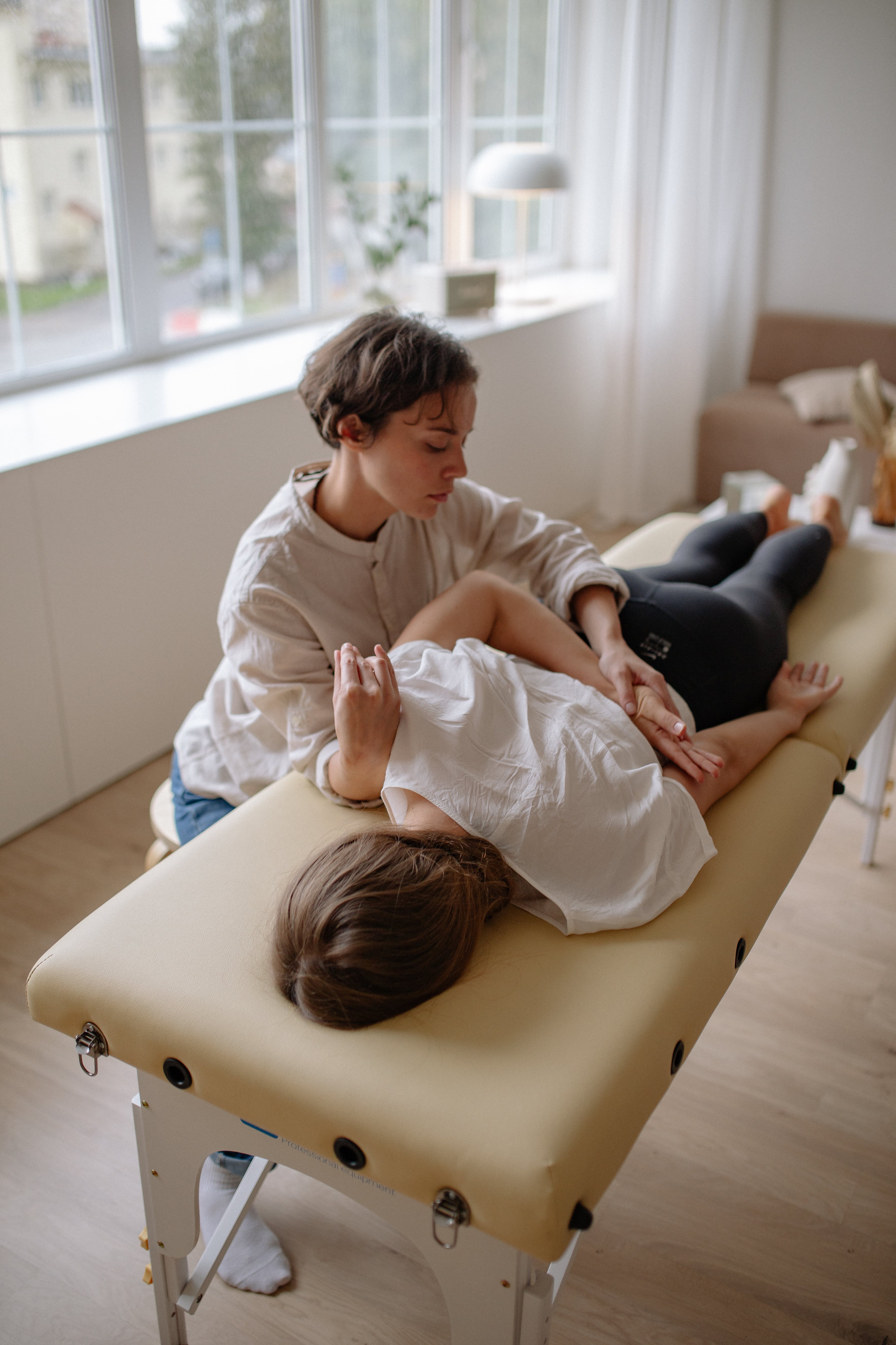 young woman getting chiropractic adjustment in New York at KIRO