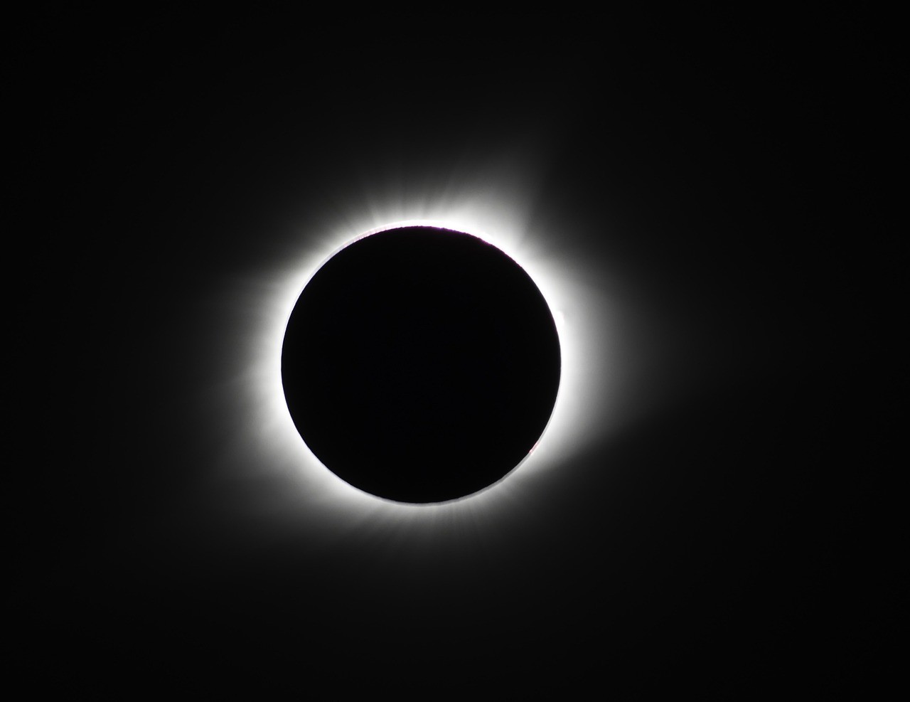 Total solar eclipse showing the sun's corona visible around the moon's silhouette