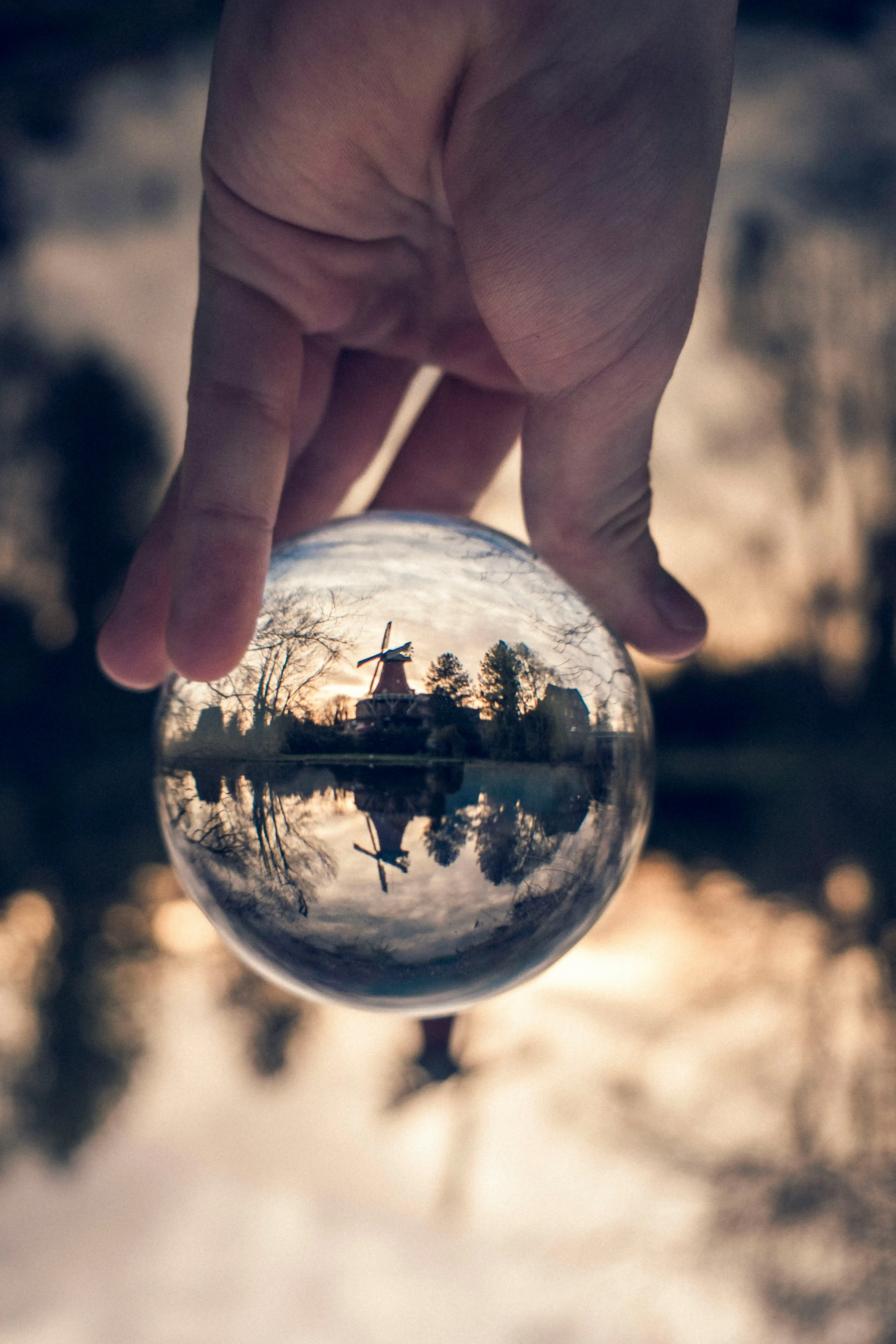 person holding clear glass ball