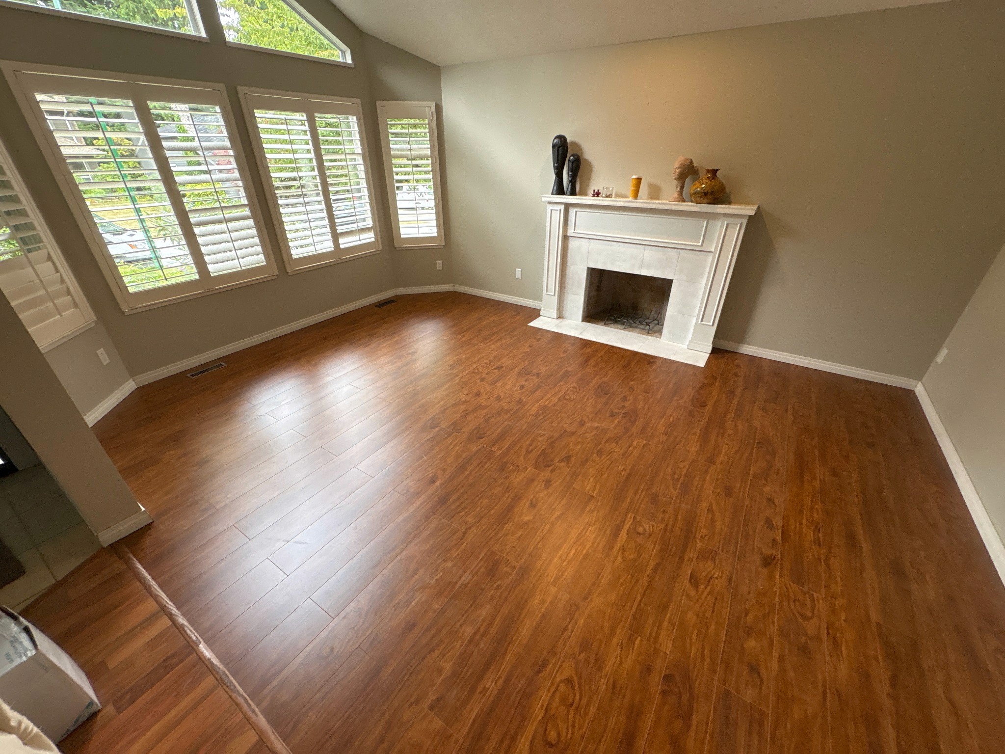 Completed living room flooring replacement showing the new hard-surface floor throughout the space.
