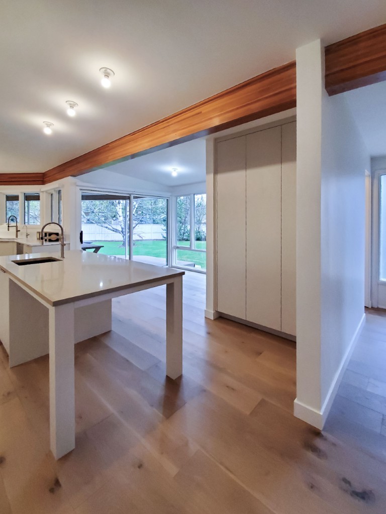 Image of KHD Homes kitchen design with island, layout design, and interior design elements, featuring hardwood floors.